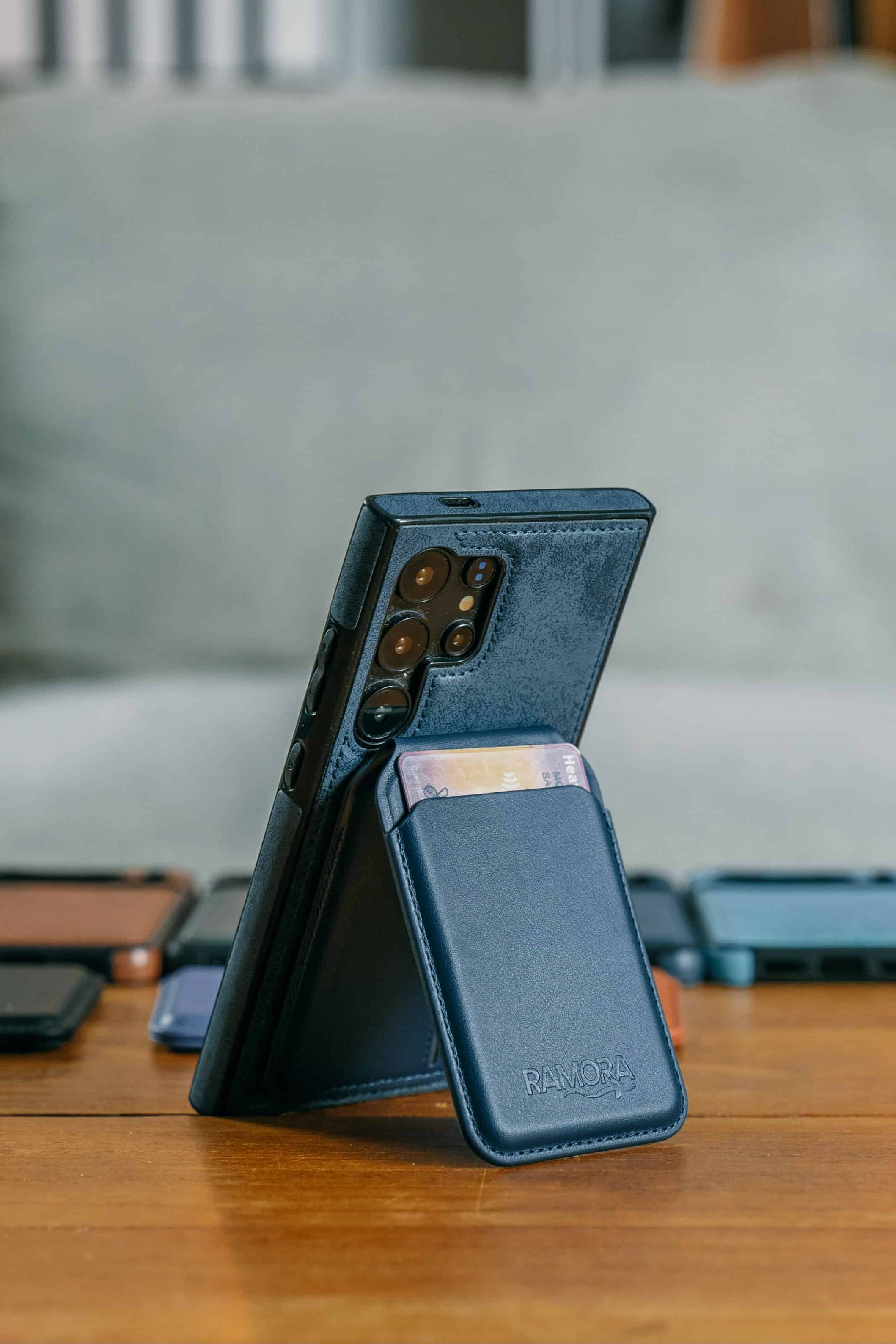 Smartphone with a blue case on a wooden table with a blurred background