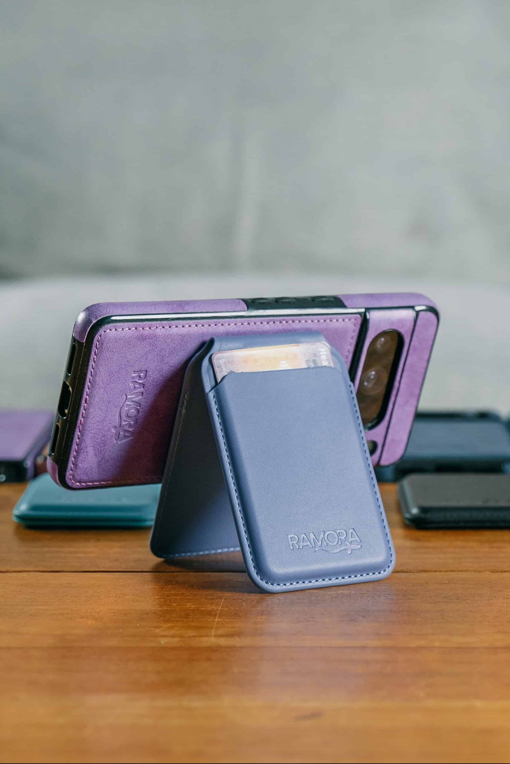 Phone cases displayed on a wooden table with a blurred background of a living room.